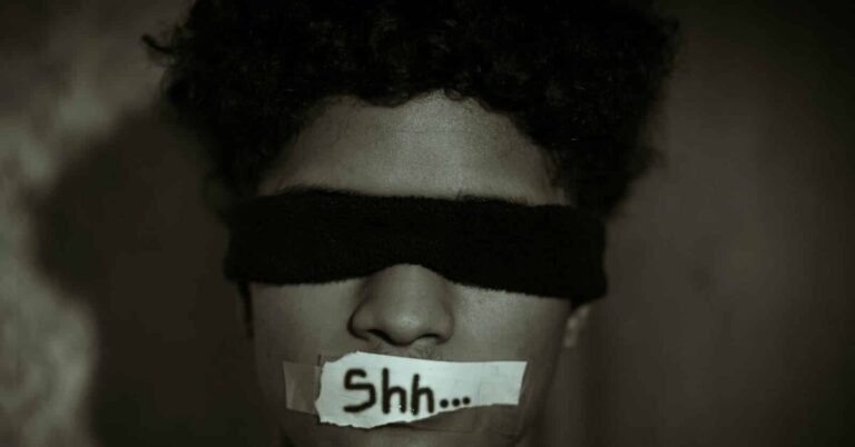 Subjugation grayscale photo of man with black face mask